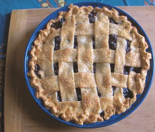 overhead shot of blueberry pie with lattice top browned crust