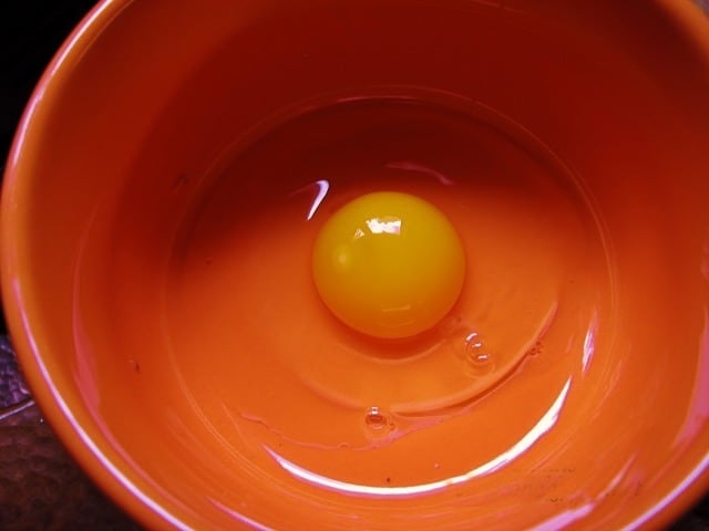 egg in an orange bowl for egg wash.