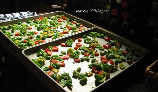 Bell pepper pieces spread out onto two baking sheets