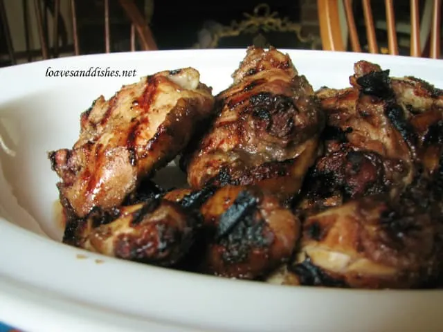 Close up of a platter of grilled jerk chicken thighs