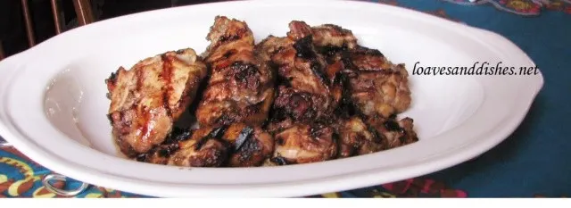 White platter holding 8 grilled jerk chicken pieces