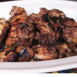 grilled chicken thighs on white plate
