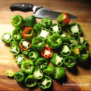 Bell Peppers ready to be seeded on a cutting board