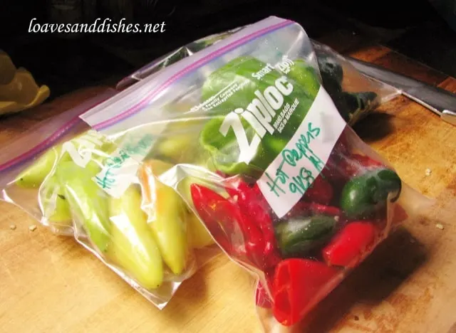 hot peppers in a quart sized freezer bag on a cutting board