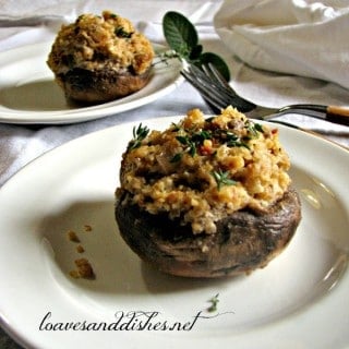 Quinoa and Asiago Stuffed Mushrooms on white plates with two forks and white napkins