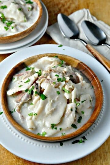 old fashion chicken and dumplins with fresh parsley sprinkled on top