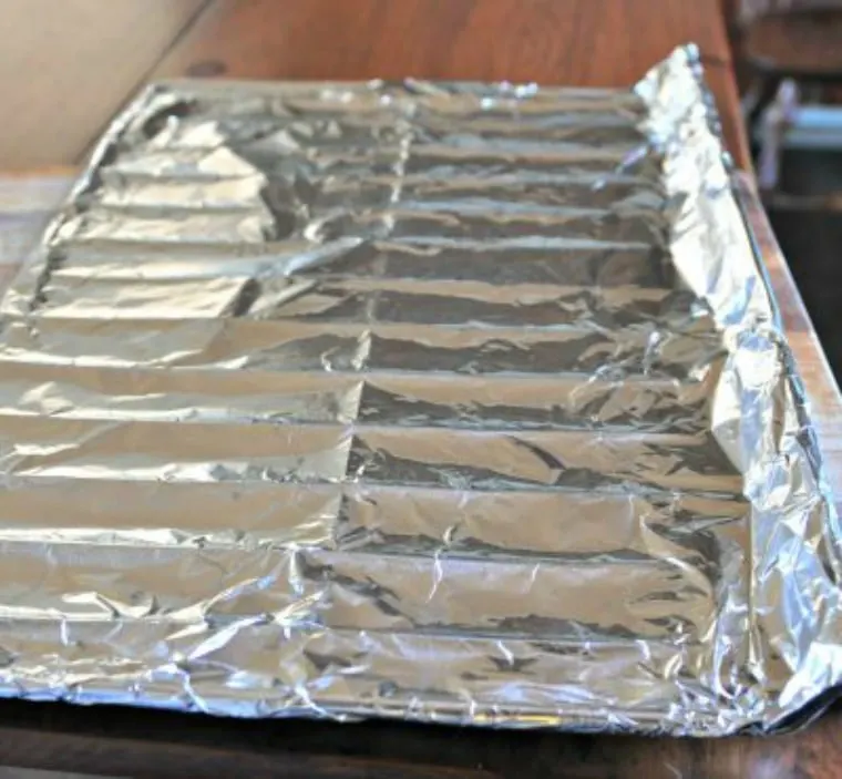 The bottom rack for the oven covered in foil for how to season a cast iron skillet