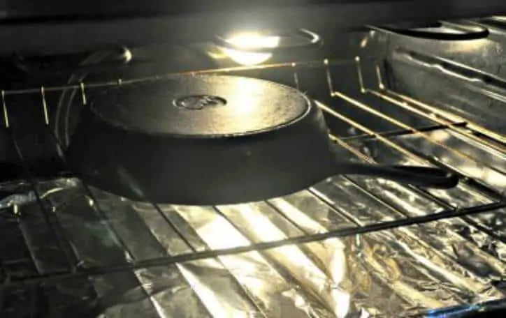 A photo of the pan in the oven for how to season a cast iron skillet