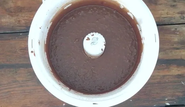 A mixer bowl of bubbly chocolate cake batter
