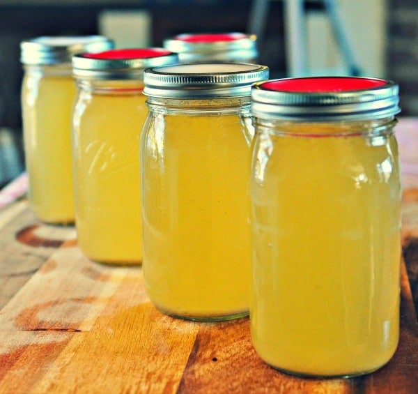 Easy Chicken Stock in quart jars with red and white lids