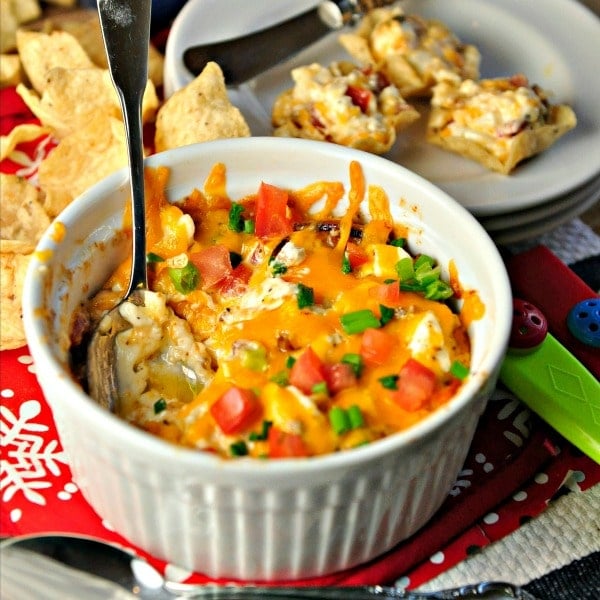 Dip with spoon and dip on crackers in background