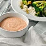 A photo of a bowl of Yum Yum Sauce beside a plate of broccoli and rice for Yum yum sauce