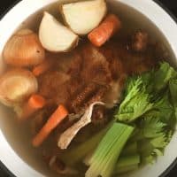 a stockpot full of onion, carrots, celery