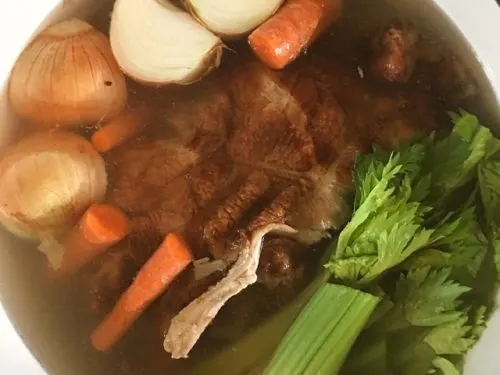 a stockpot full of onion, carrots, celery