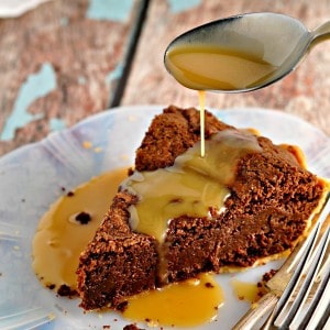 Fudge Pie with Salted Caramel Sauce being spooned on top