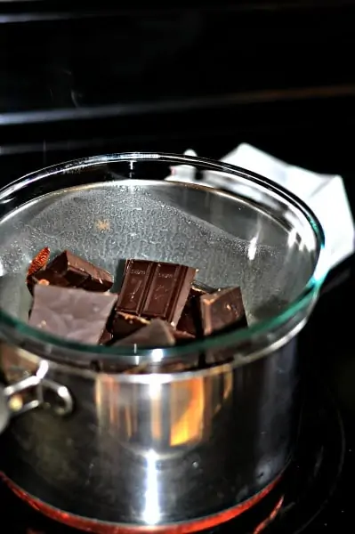 chocolate being melted in a pot of the stove