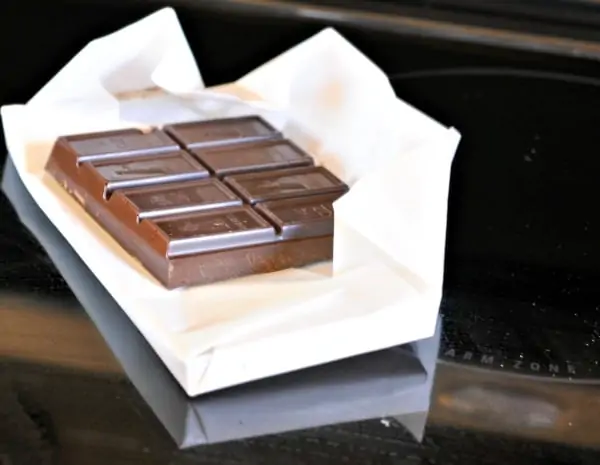 chocolate bar in white paper on a counter top