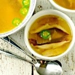 Roasted Chicken, Shiitake and Jalapeno Soup in a white bowl and two spoons