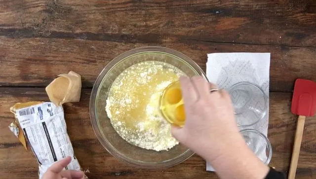 A photo of adding the oil water and eggs to the cookie mix