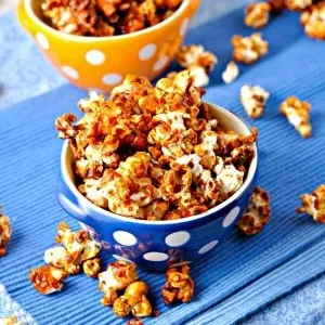 Freaky Hot Wing popcorn in a blue and yellow polka dot bowl on a blue towel