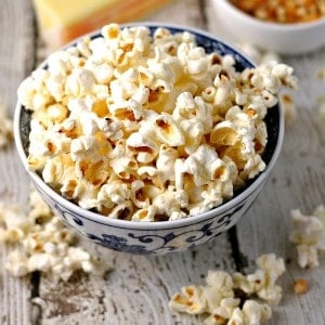 Popcorn in a blue and white bowl on a wooden table