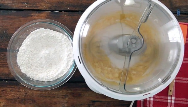 the wet ingredients in the mixer with the dry ingredients in bowl beside