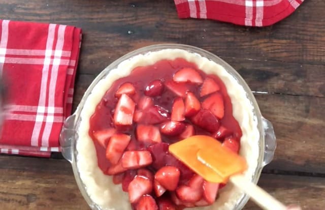 pie shell with filling in glass pie plate, red napkins