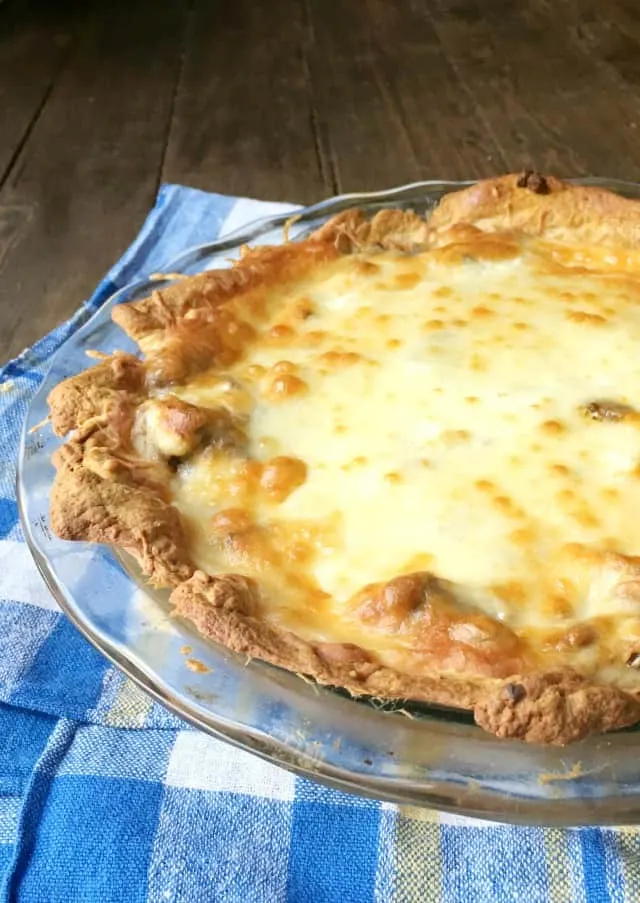 Taco Pie from the side in glass plate on blue towel