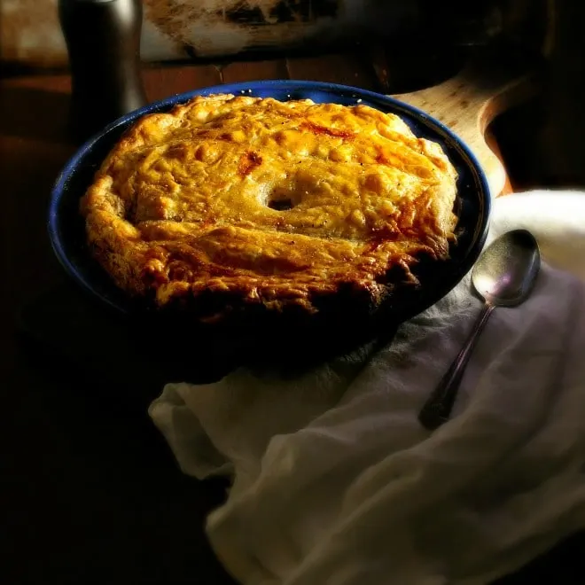 Chicken Pie and Puff Pastry in a blue dish with a white napkin