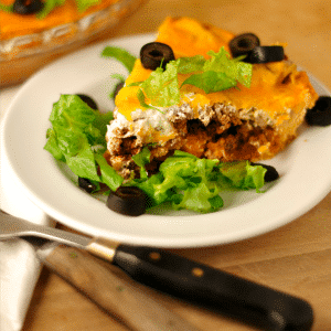 Taco Pie on a white plate with a few bites taken out of it