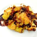 Chocolate Chip Bread Pudding on a white plate with a chocolate smear on the plate