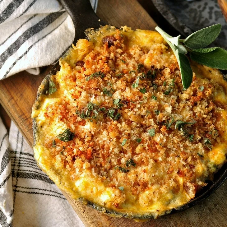 Chicken Casserole with a black and white napkin and fresh sage