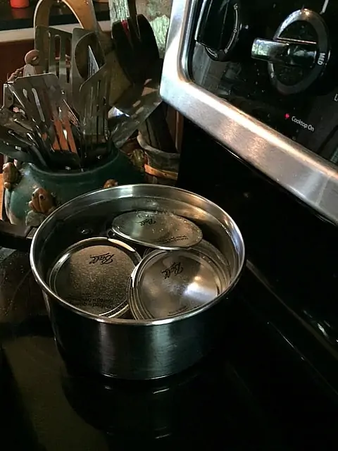 jar lids in sauce pan on the stovetop