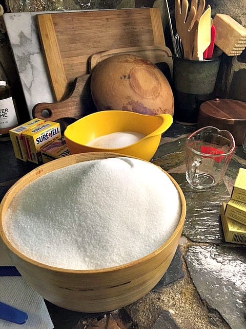 two bowls of sugar with cutting boards in background standing on edge for organization