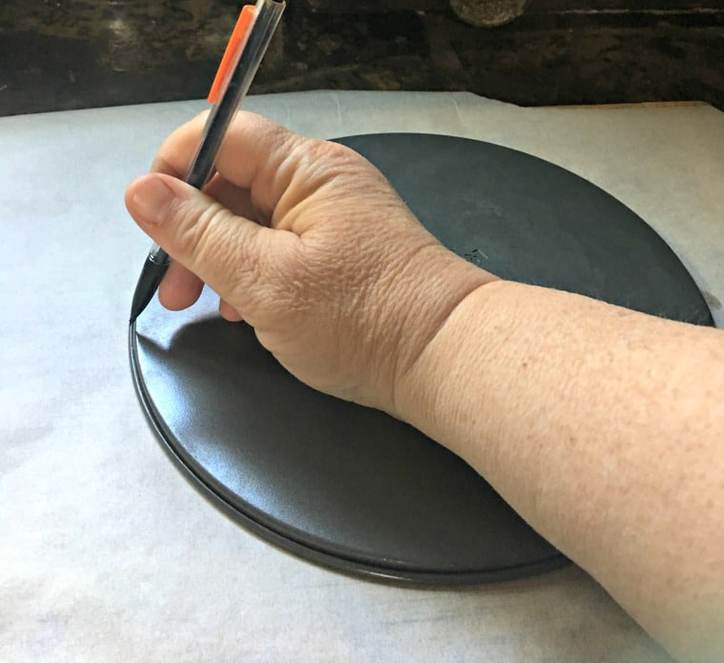 A picture of drawing around the bottom of the cake form for Cinnamon Roll Cake from Scratch