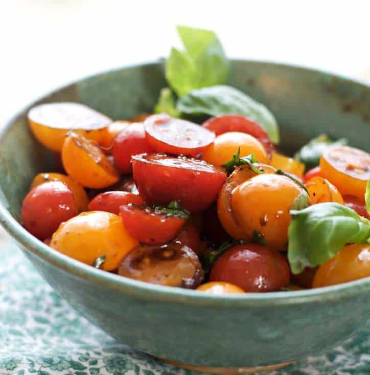 Delicious summer cherry tomatoes in a green bowl for how to peel and seed a tomato