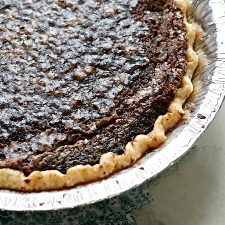 A photo of the chocolate chess pie from overhead showing only one quarter of the pie and showing off the browned edges