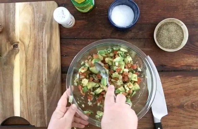 Mixing all the ingredients in a glass bowl with a spoon