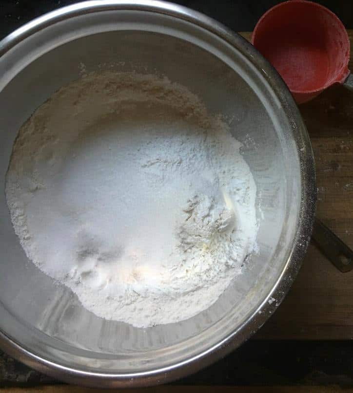 a photo of the dry ingredients together in a bowl for cinnamon roll cake from scratch