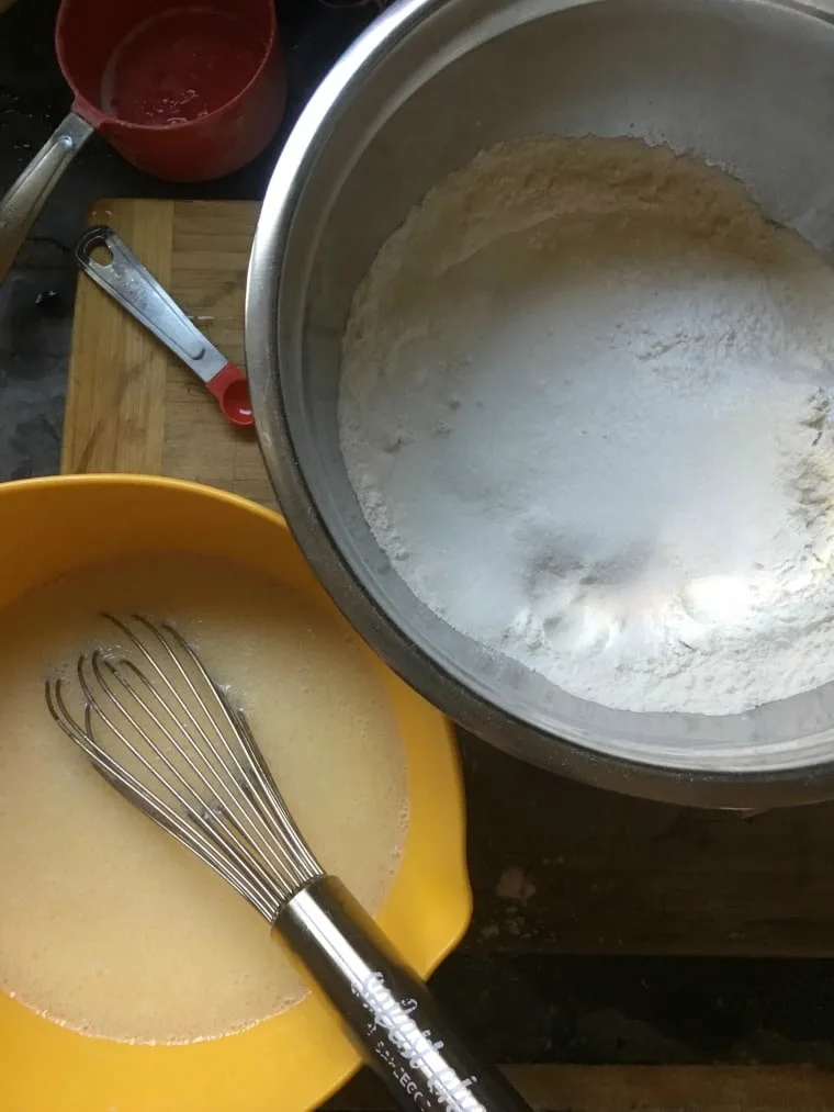 A photo of the wet ingredients whisked together sitting with the dry ingredients.