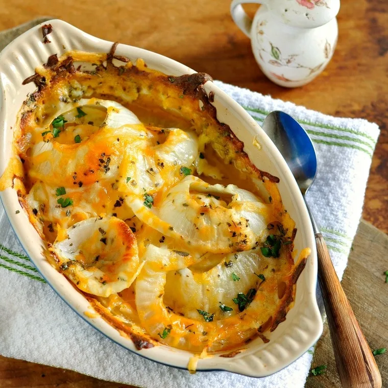 casserole dish of tennessee onions with a salt shaker and white towel