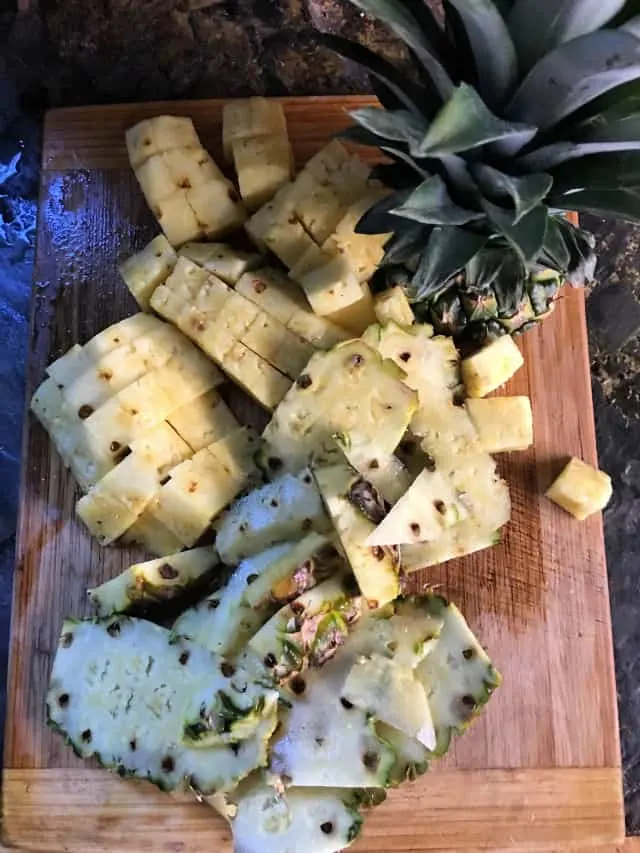 cutting board with cut up pineapple on it
