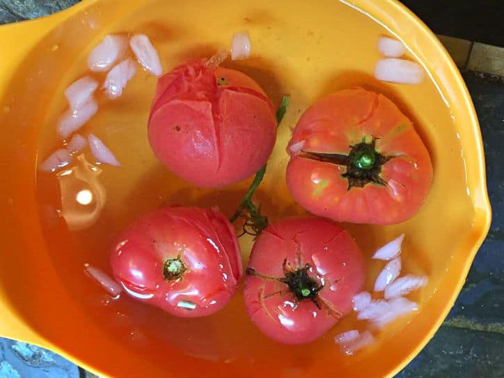 tomatoes in a yellow bowl of ice water