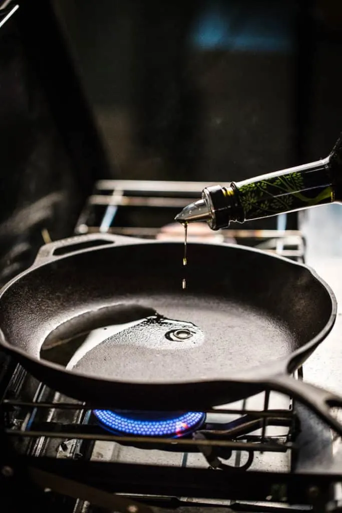 a cast iron frying pan on a gas stove