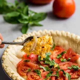 Adding ingredients for tomato pie