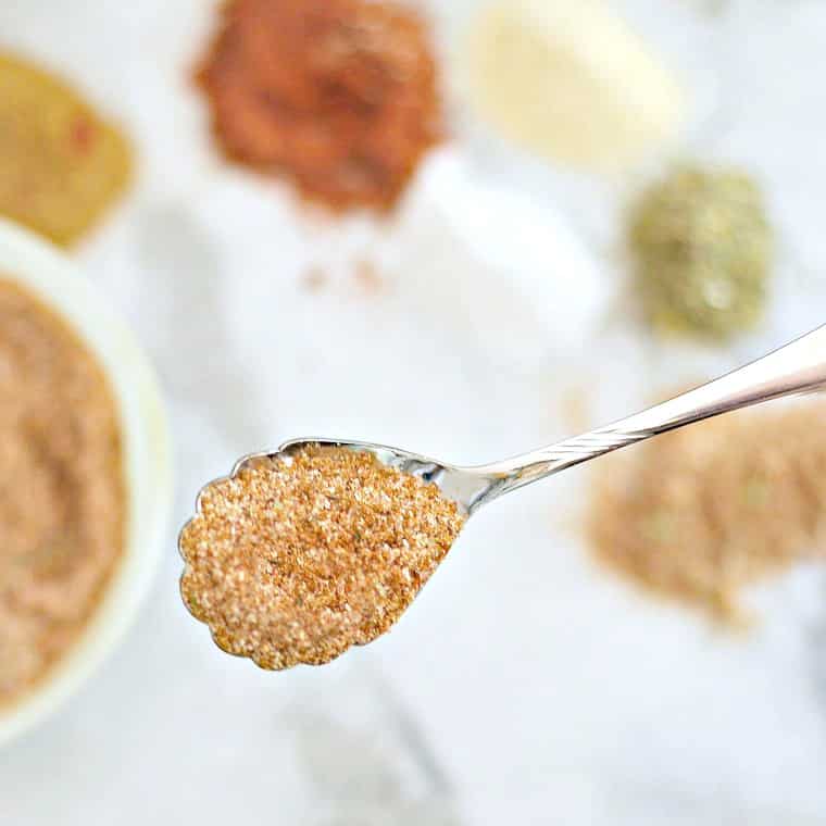 A photo of a spoonful of dry spice rub for steaks