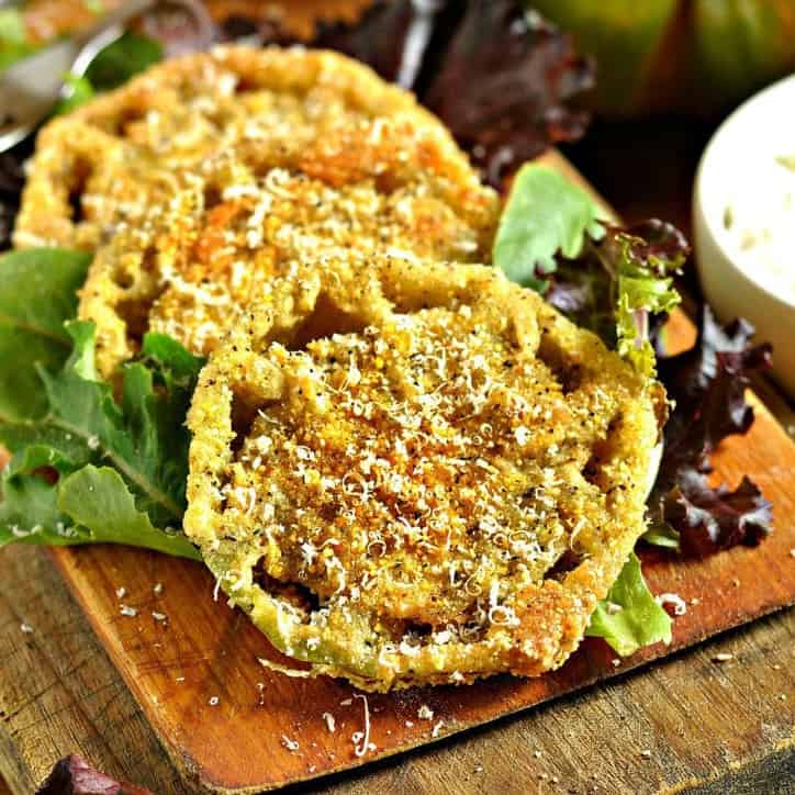 A cutting board with fried green tomatoes on top