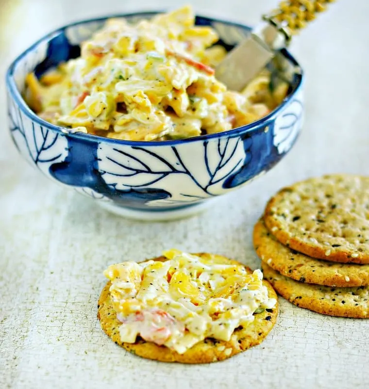 A photo of a bowl of pimento cheese with crackers