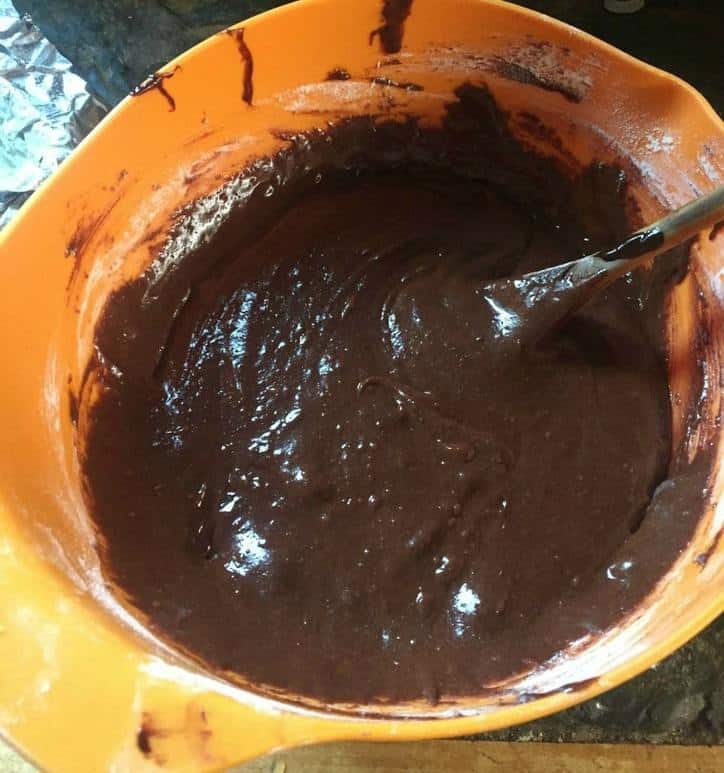 orange mixing bowl with brownie batter inside