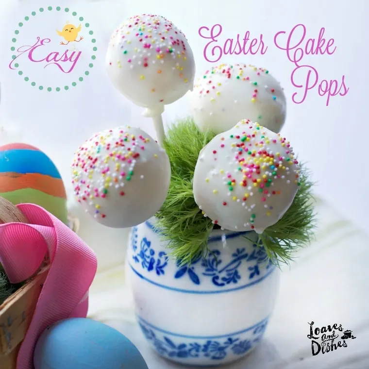 White cake pops with rainbow sprinkles in a blue and white jar. Easter Eggs in foreground
